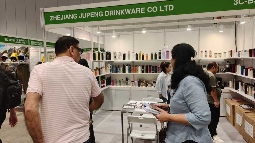 Close-up inspection of powder-coated and laser-engraved vacuum flask samples